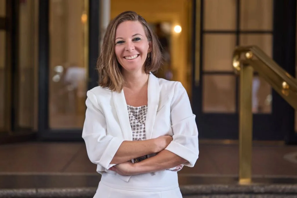 Lady Nicole M. Weber smiling in a white suit